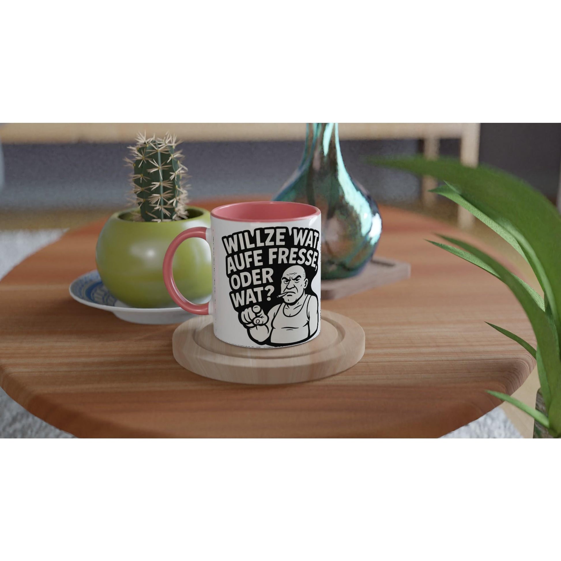 Ruhrpott Tasse lustig mit Spruch und rotem Griff auf Holztisch neben Pflanze