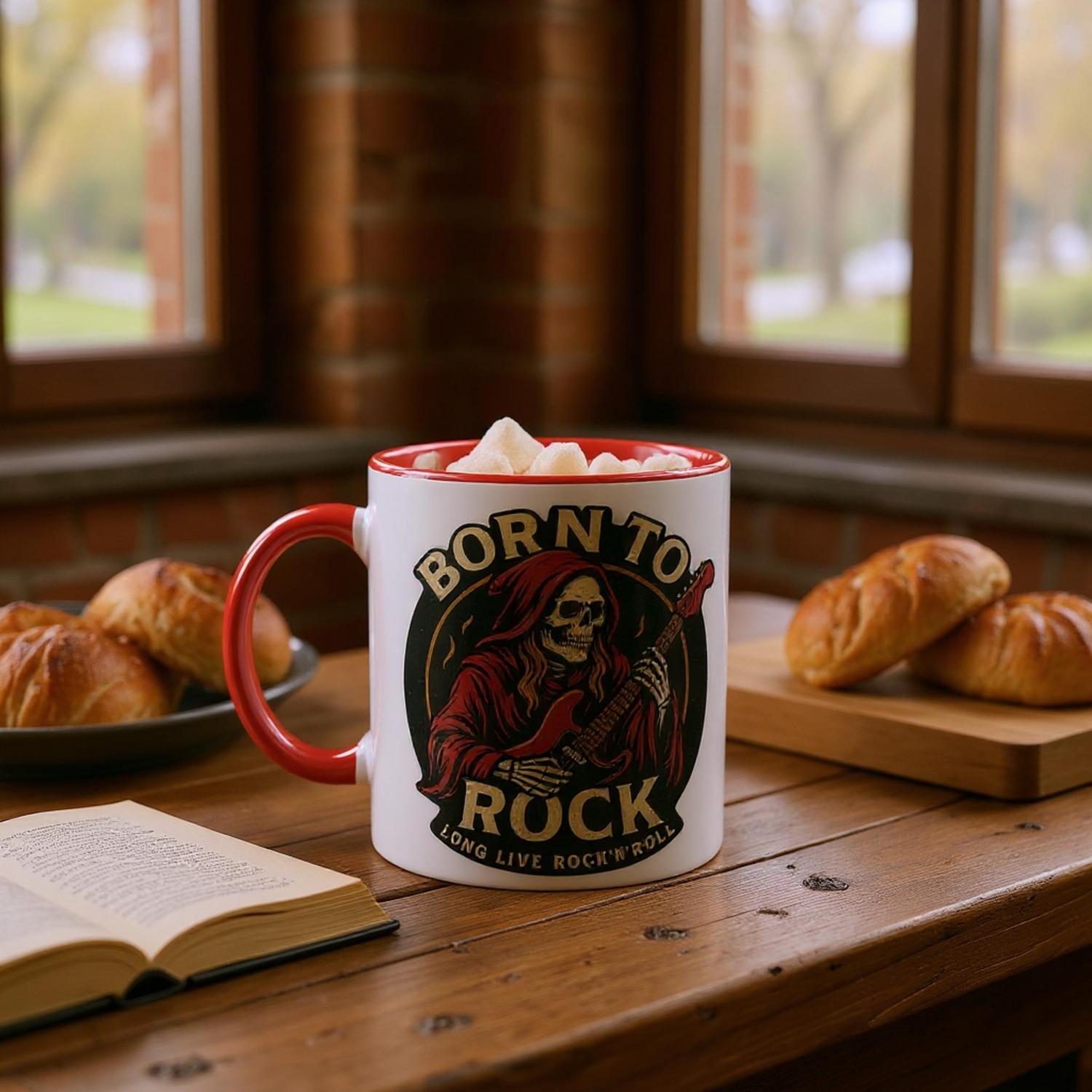 Tasse Born to Rock Geschenk von Wupperlike mit Totenkopf und E-Gitarre auf Holztisch mit Buch und Brötchen